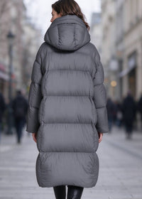 Full back view of woman wearing dark grey longline quilted down puffer parka coat