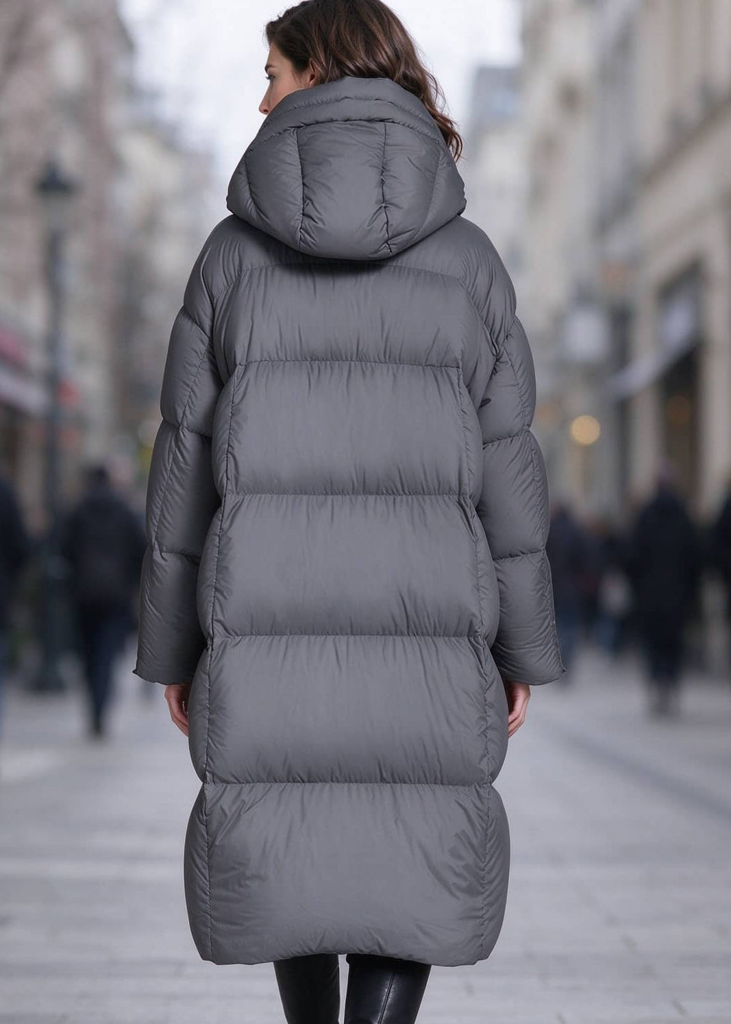 Full back view of woman wearing dark grey longline quilted down puffer parka coat