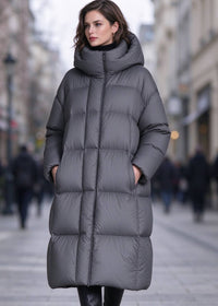 Front view of woman wearing zipped dark grey longline high collar down puffer parka