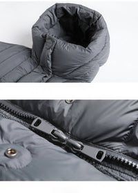 Close-up detail of dark grey puffer coat funnel hood and double two-way zipper hardware