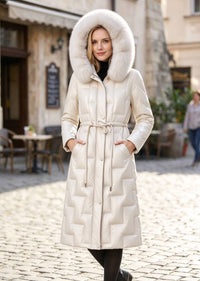 Front portrait of woman with hood up wearing cream beige Vivian Seven genuine leather down parka with plush fur hood