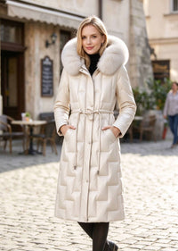 Front portrait of woman with hood up wearing cream beige Vivian Seven genuine leather down parka with plush fur hood