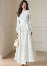 Studio shot of the Vivian Seven long sleeve white tweed maxi dress showcasing the elegant textured fabric and high-waisted silhouette.