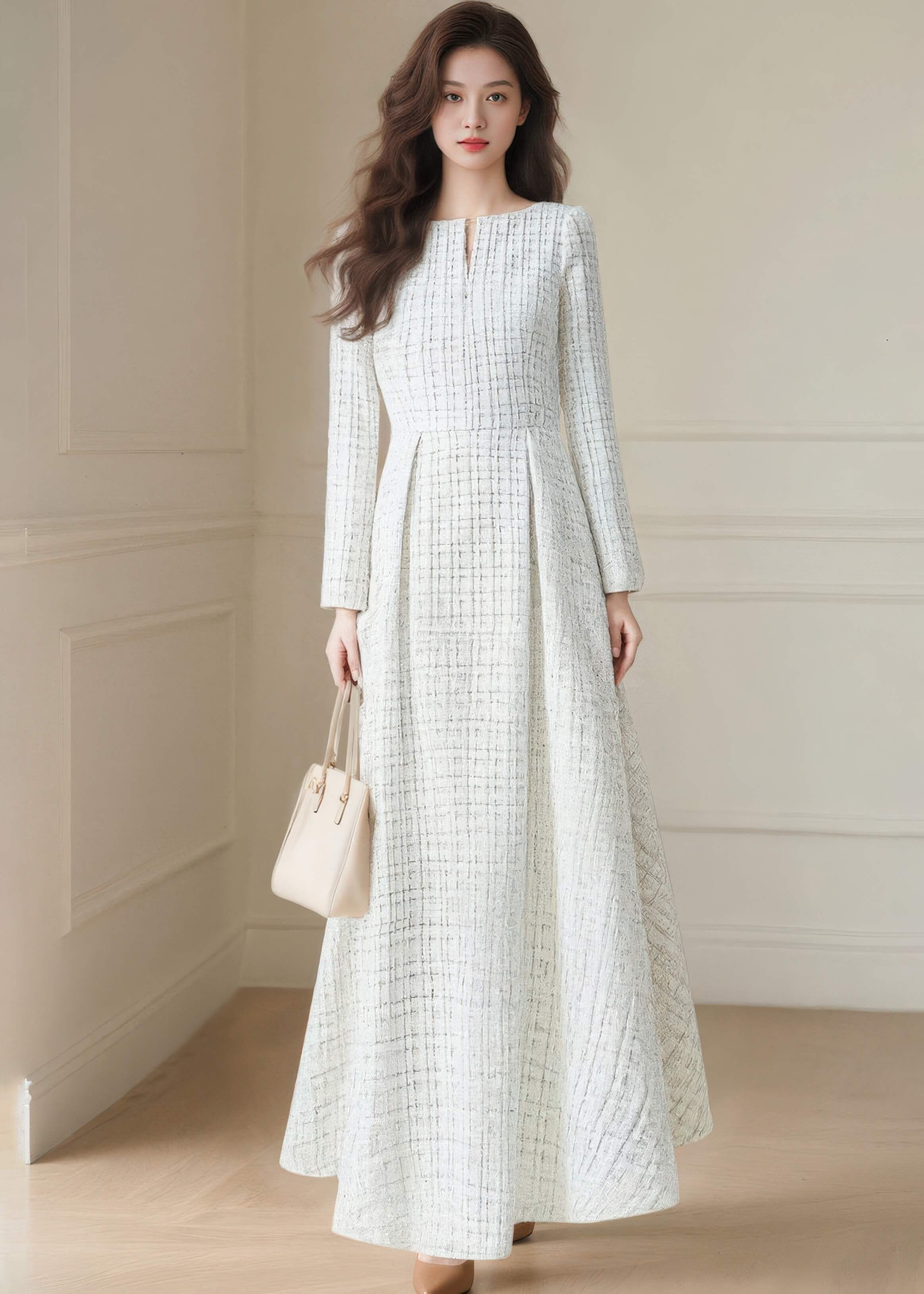 Studio shot of the Vivian Seven long sleeve white tweed maxi dress showcasing the elegant textured fabric and high-waisted silhouette.