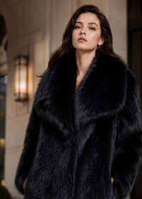 Portrait close-up showing the oversized wide collar detail and plush material of a black faux fur coat
