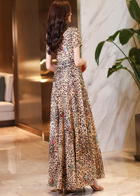 Back view of the leopard print maxi dress showing the tailored fit and flowing chiffon-style fabric.