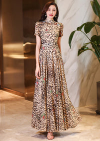 Full pose of an A-line leopard print evening maxi dress with a modest high collar and short sleeves.