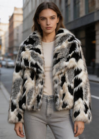 Close-up front view of a model in a black and white abstract print cropped plush faux fur coat by Vivian Seven.