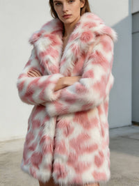 Model with arms crossed wearing a women's blush pink and white patterned faux fur coat.