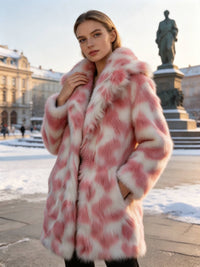 Woman posing outdoors in winter wearing a blush pink patterned faux fur coat with side pockets.
