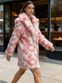 Side view of a model walking outdoors in a mid-length blush pink patterned faux fur coat.