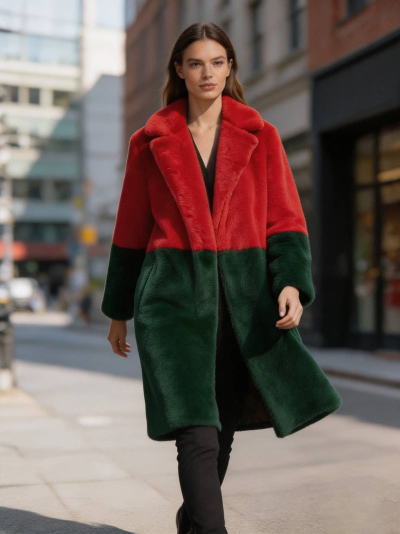 Model walking forward on a city sidewalk wearing a red and dark green colorblock plush faux fur long coat.