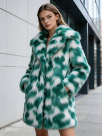 Model with hands in pockets posing outdoors in an emerald green patterned plush faux fur coat.