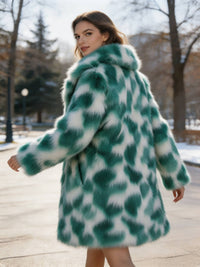Dynamic back view of a woman turning in a park wearing an emerald green patterned faux fur coat.