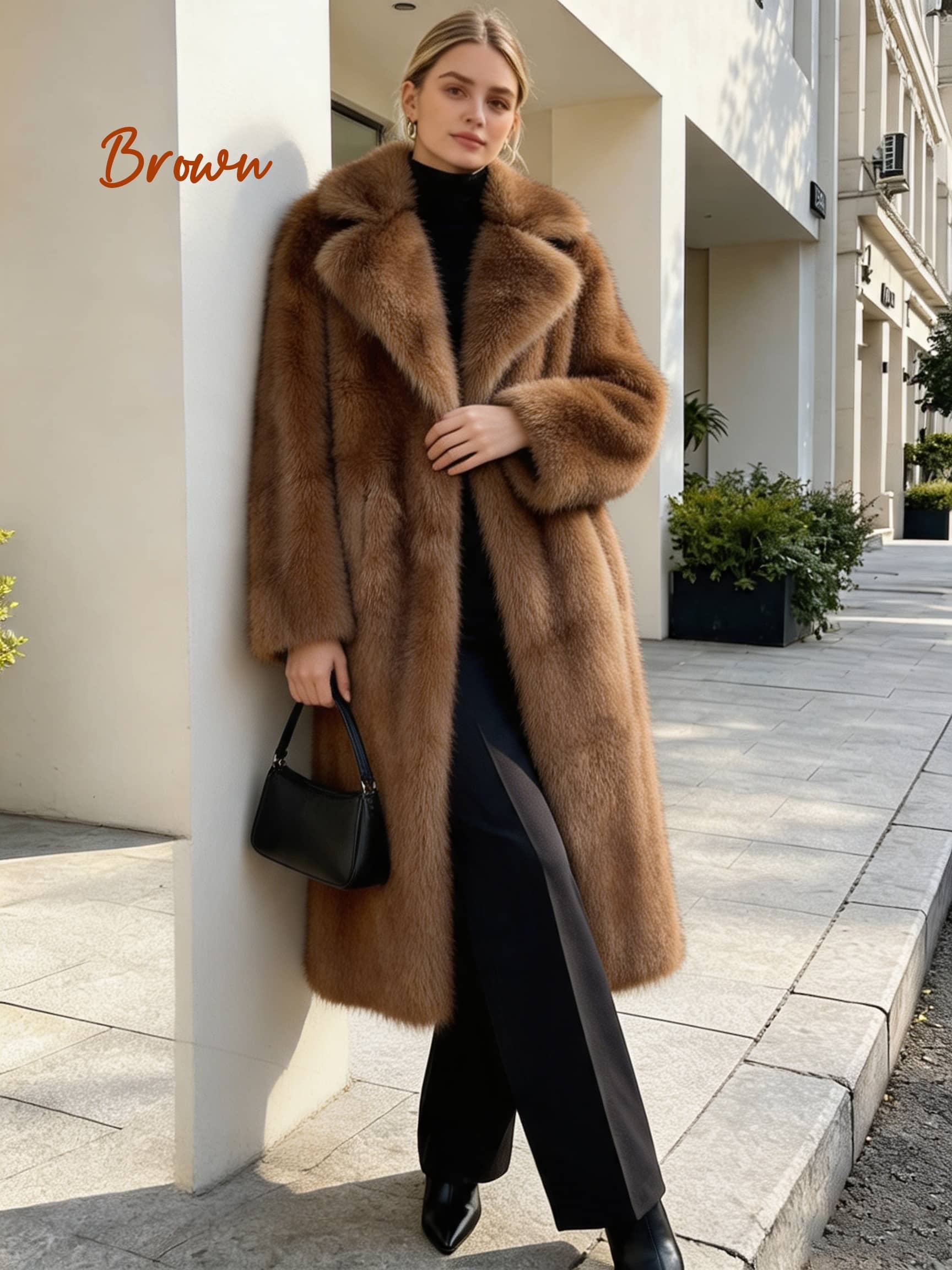 Model in a long warm brown faux fur winter coat holding a small black shoulder bag on a city street.