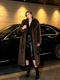 Elegant woman in a dark coffee brown long faux fur outerwear coat, leather midi skirt, and black boots next to a luxury car.