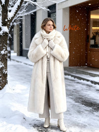 Front view of a woman wearing an open long brown faux fur coat with black wide-leg pants and heel boots.