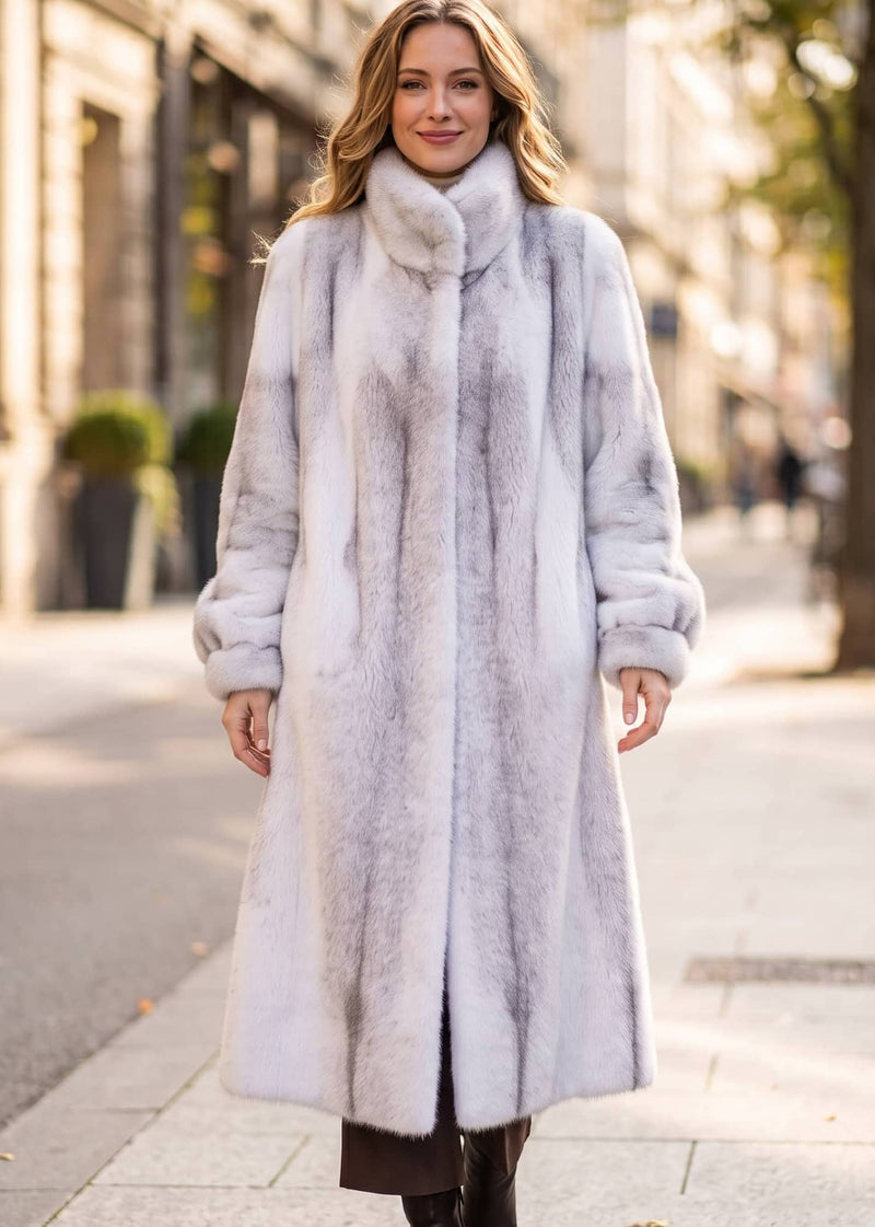 Front-facing full-length street view of an elegant woman wearing a frosted funnel-collar faux mink long coat.  