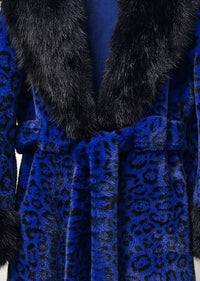 Close-up detail of royal blue leopard print faux fur coat with black plush collar and tie belt