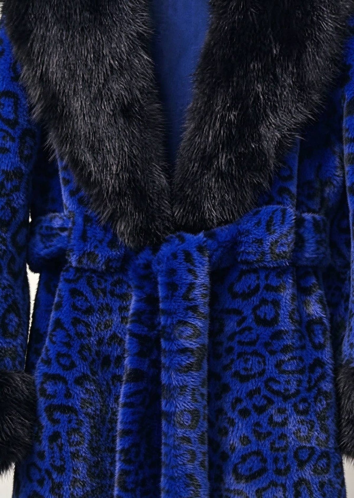 Close-up detail of royal blue leopard print faux fur coat with black plush collar and tie belt
