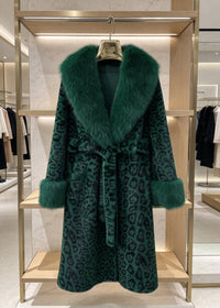 Emerald green leopard print belted long faux fur coat with matching plush collar hanging on rack