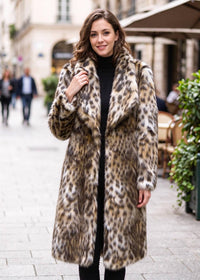 Front-facing full-length view of an elegant woman wearing a leopard print faux fur midi coat over a black turtleneck.  