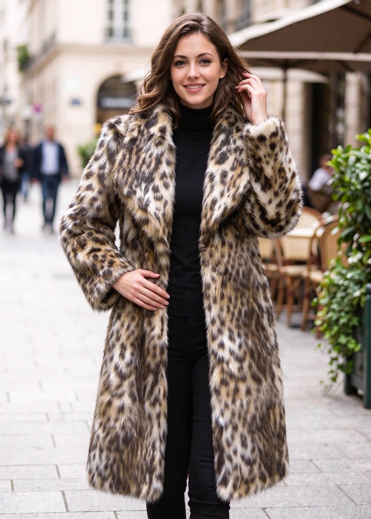 Three-quarter outdoor fashion look of a woman wearing an open-front leopard print faux fur coat with spread collar lapels.  