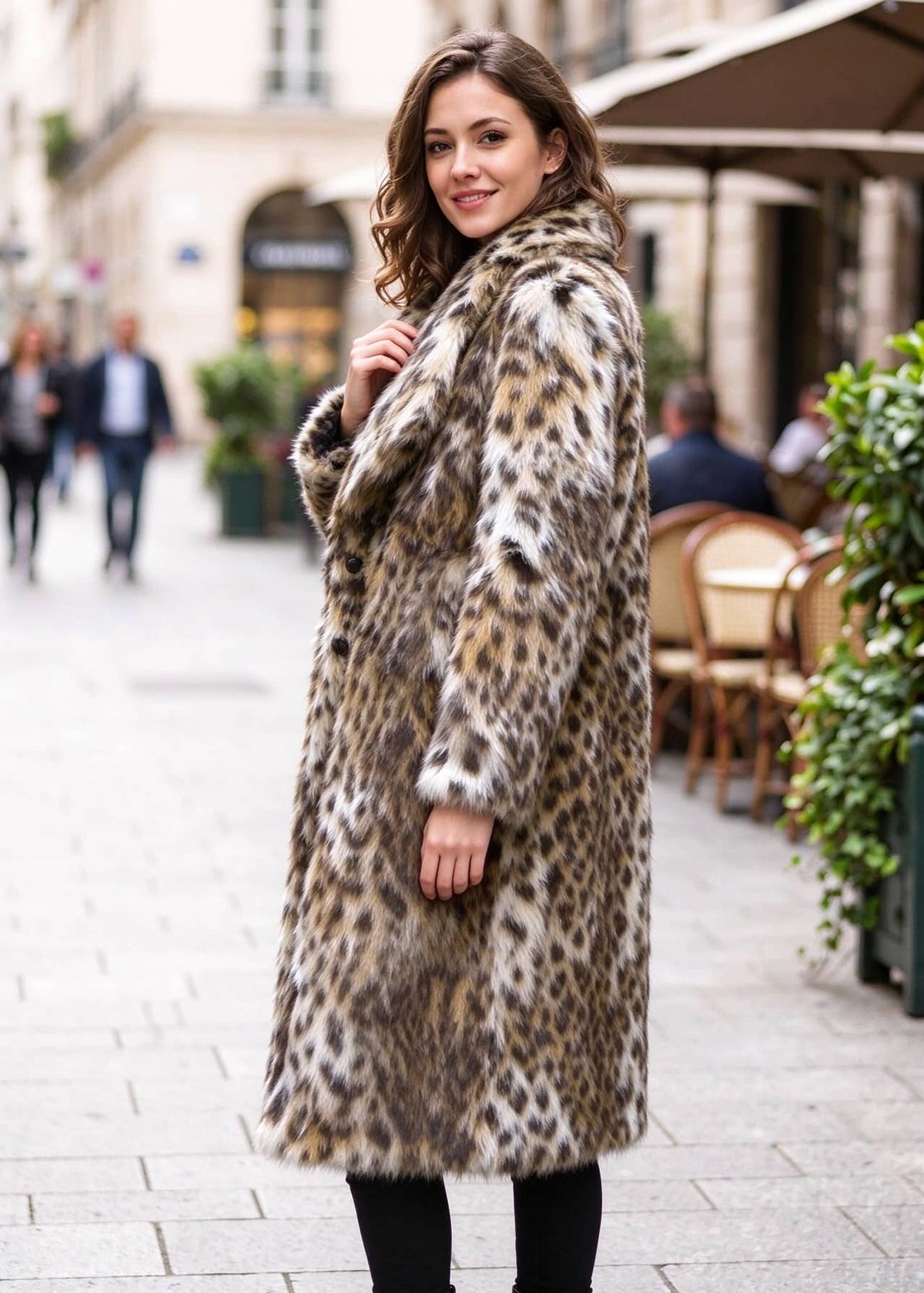 Three-quarter side perspective of a woman wearing a plush leopard faux fur midi coat highlighting sleeve and hem length.  