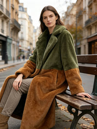 Woman resting on a park bench wearing an olive green and rust colorblock plush faux fur long coat.