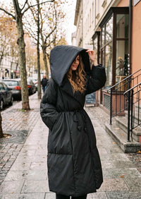 Vivian Seven women's black hooded down puffer coat featuring deep oversized hood and belt