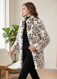 Dynamic side-angle walking pose of a woman modeling the snow leopard stand-collar faux mink coat indoors. 