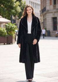 Elegant full-length street view of a woman wearing an open-front black faux mink longline coat with spread collar.