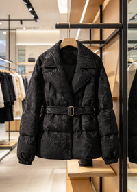 Black women's textured jacquard goose down jacket with lapel collar hanging on clothes rack