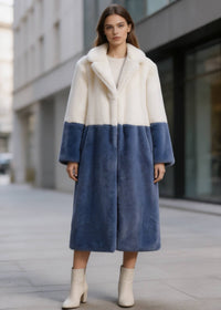 Full-length front shot of a model wearing a cream white and slate blue two-tone notch collar faux fur long coat.
