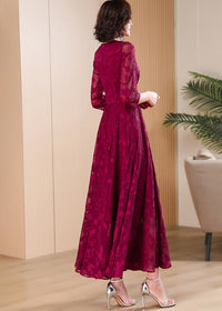 Back profile of Vivian Seven burgundy flowy maxi dress showing elegant silhouette and sheer sleeves.