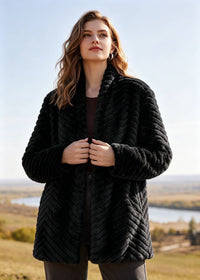 Front close-up view of woman wearing elegant black chevron pattern shawl collar faux fur jacket