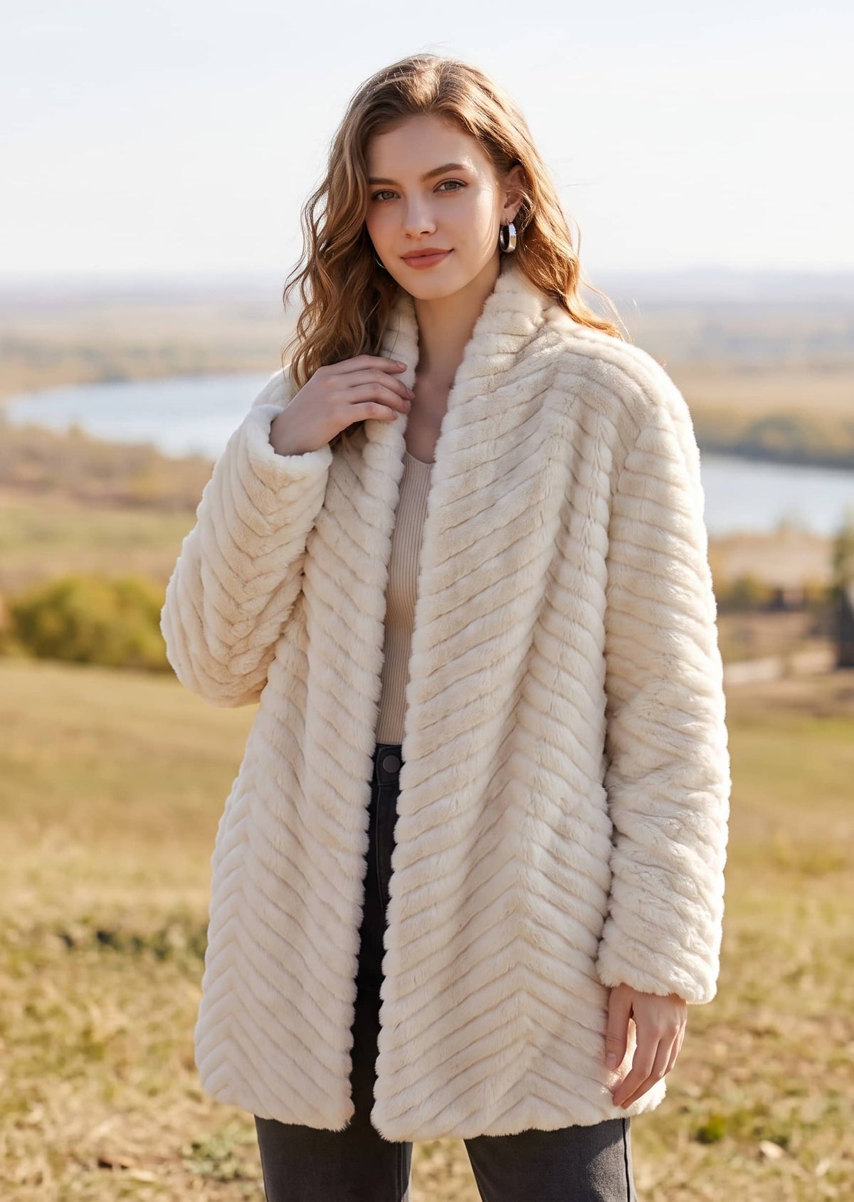 Front three-quarter pose of woman in cream chevron pattern faux fur coat with shawl lapel