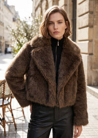 Medium front-facing shot showcasing the notch lapel and fluffy texture of an espresso brown women's cropped faux fur winter coat.