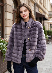 Full front shot of a woman in a purple horizontal striped faux fur cropped coat with stand-up collar