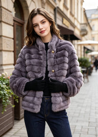 Front close-up view of a women's lavender purple stand collar faux fur crop jacket featuring horizontal grooves and embossed buttons