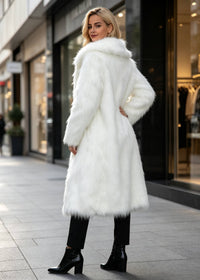 Back and side profile shot highlighting the length and shaggy texture of a women's pure white longline faux fur trench coat.