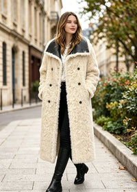 Full-length view of the cream fluffy teddy shearling side of the double-breasted long winter coat.