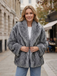 Front view of an unbelted open dark gray faux fur jacket showing the oversized shawl lapel design