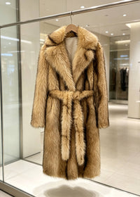 Camel tawny brown faux fur wrap coat with self-tie belt displayed on a clothing rack.