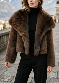 Close-up of model wearing rich brown cropped faux fur jacket with oversized turn-down collar